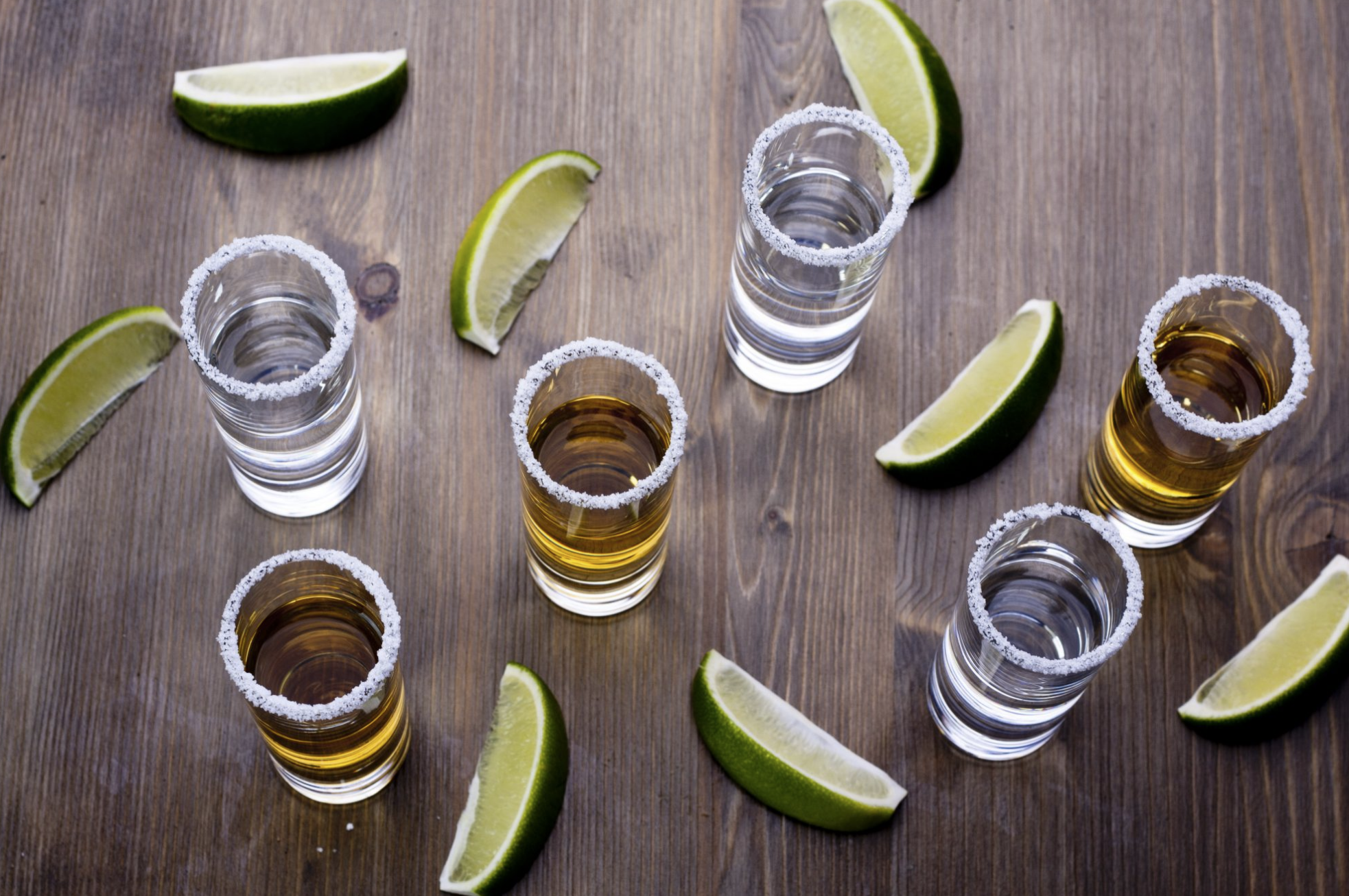 Lime and tequila in glasses with salt